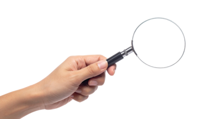 Hand holding a magnifying glass against a black background, showing detail