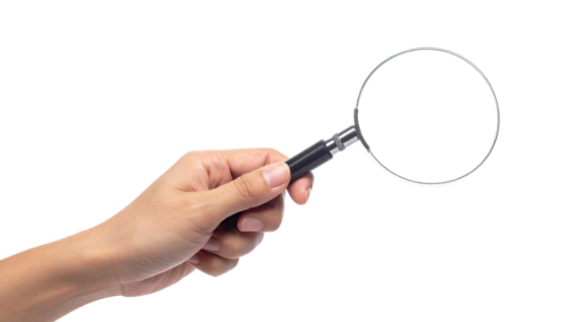 Hand holding a magnifying glass against a black background, showing detail