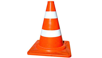 A brightly colored traffic cone with white stripes, isolated on a black background