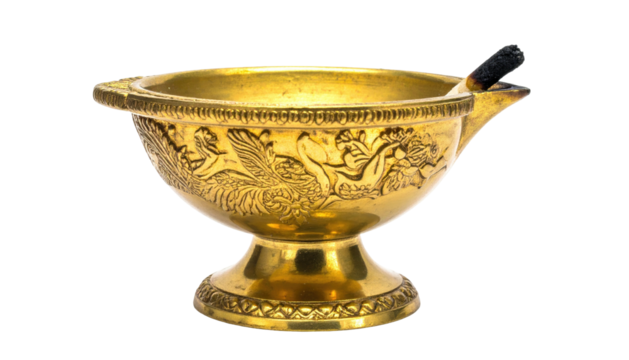 Ornate gold oil lamp with detailed reliefs, small spout, and burnt wick