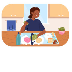 Woman washing dishes in a kitchen sink with sponges and soap with a pink potted plant on the counter and blue towel on the wall