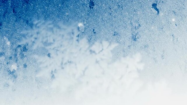 Close-up of intricate snowflakes against a shimmering blue background, creating a winter wonderland effect