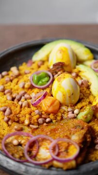 Vertical Video, Eto with Groundnut and Avocado, Mashed Ripe Plantain Mixed With Palm Oil, Onions, and roasted groundnuts, Africa Ghana Traditional Dish