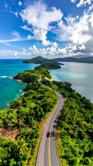 Scenic aerial shot of a curving road winding through lush, tropical foliage