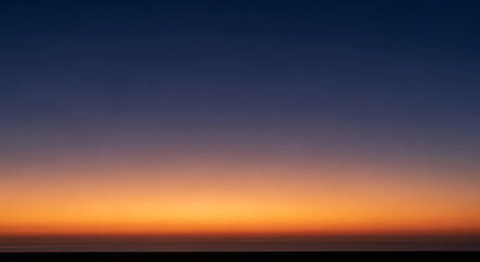 Vibrant sunset sky with gradient of orange and deep blue colors