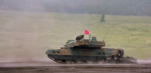 The camouflage-painted armored personnel carrier traverses the muddy terrain, leaving visible...