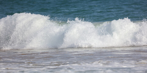 The ocean is rough and the waves are crashing