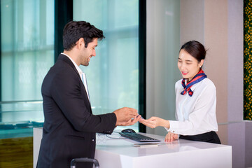 A businessman passenger check in at airport couter for travel by airline business service.