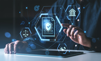 Digital contract protection concept with hologram icons above a tablet showing cybersecurity and...