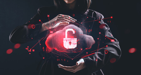 Woman holding digital hologram of red cloud with unlocked padlock symbol representing cybersecurity breach concept on dark background..
