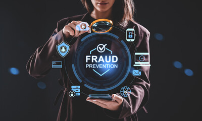 Woman analyzing fraud prevention hologram concept using magnifying glass on futuristic interface in cybersecurity context on dark background.