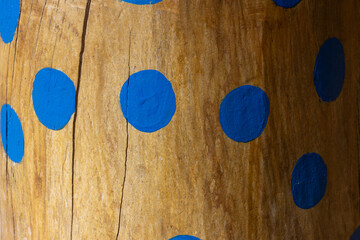 Blue dots on wood texture.