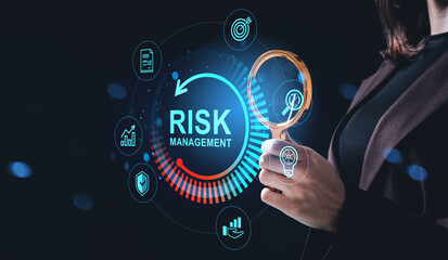 Businesswoman analyzing risk management hologram interface with magnifying glass on dark background, futuristic business strategy concept.