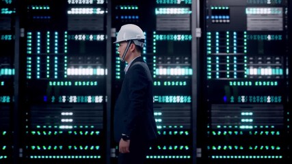 Side View of Asian Businessman Walking in Server Room Data Center - Powered by Adobe