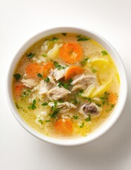 Creamy chicken soup in a white bowl