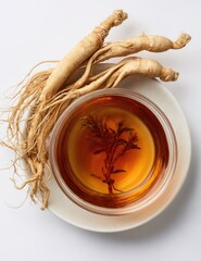 Fresh ginseng roots beside a cup of golden tea