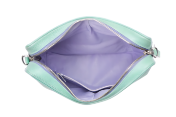 Open mint green crossbody bag with purple interior and zipper detail on black background