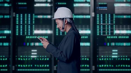 Side View of Asian Businesswoman Use Tablet While Walking and Looking Around in Server Room Data Center - Powered by Adobe