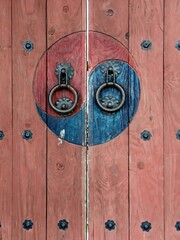Traditional Korean wooden door decorated with Taegeuk patterns - Taegeuk symbol is typically associated with Korean traditions and represents balance in the universe