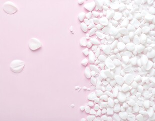 Delicate white petals and pebbles on a pink backdrop
