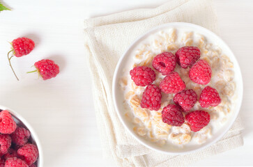 Oatmeal porridge with raspberries in bowl
