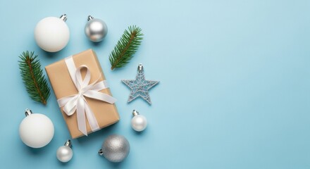 Elegant Christmas Gift Box with Ornaments and Pine Sprigs on Soft Blue Background