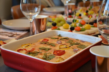 Homemade Focaccia on Festive Table with Appetizers and Elegant Dinner Setting
