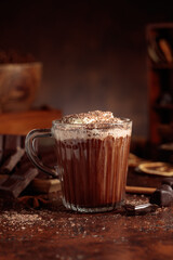Hot chocolate topped with whipped cream and sprinkled with chocolate chips.