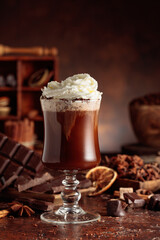 Hot chocolate with whipped cream in a glass mug.