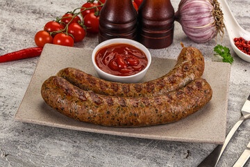 Grilled beef sausages with sauce