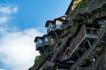 Fototapeta premium Houses built on a steep cliff with unique architectural style