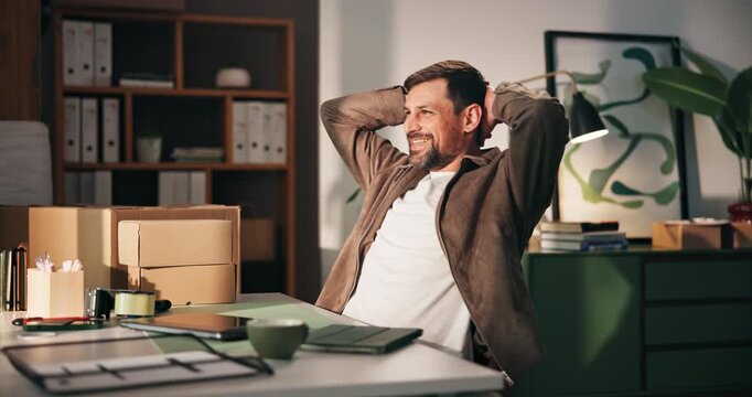 Laptop, relax and thinking with man in logistics office for delivery, distribution or shipping. Computer, hands behind head and supply chain with happy person at desk to complete ecommerce schedule