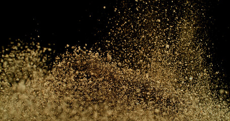Powerful burst of clay particles exploding upward in a dense cloud, isolated on black. High-speed photography capturing the dynamic texture of dry earth in motion.