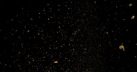 Detailed wave of airborne clay dust swirling in chaotic motion, captured in freeze  motion. Dramatic natural explosion of earthy particles on black background.