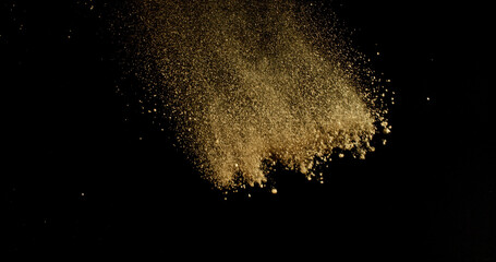 Fine beige cosmetic powder cloud suspended in air, isolated on black background. Elegant abstract motion concept captured in studio light. Makeup explosion and beauty design.