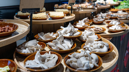 Assorted mushrooms displayed in bowls at a food display