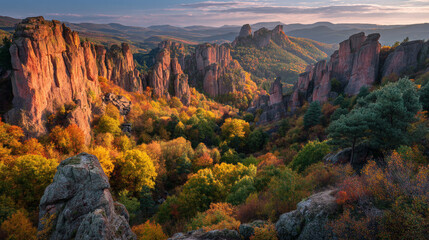 Aerial view of rock formations and autumn foliage in a mountain valley at sunset light