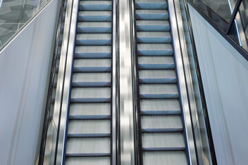 Top view of an escalator in cool colors.