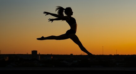 Silhouette of a leaping person against a vibrant sunset sky