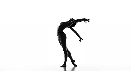 Silhouette of a person in graceful pose against a bright white background