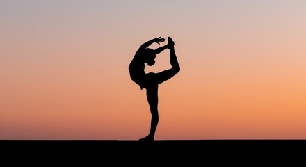 Silhouette of a person practicing yoga against a sunset sky