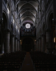 Obraz premium Historic cathedral hall with columns and rose window light