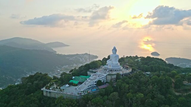 Sunset view of phuket big buddha facing the glowing sea