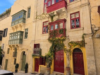 old red door in street of Valletta Malta