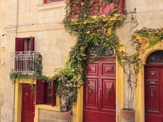 old red door in street of Valletta Malta