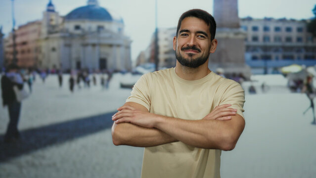 Young man stands confidently with crossed arms in vatican city's san pedro square showcasing a vibrant cityscape backdrop. - Powered by Adobe