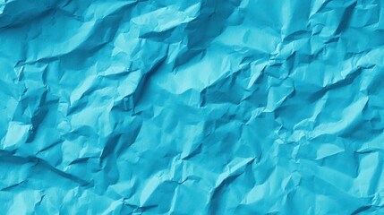Bright crumpled blue surface creating an abstract textured background for creative designs