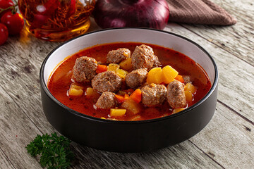 Tomato soup with meatballs and vegetables
