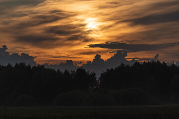 Clouds behind the forest during sunset