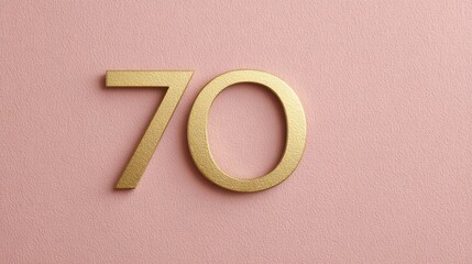 Celebrating a milestone birthday with a golden 70 on soft pink background